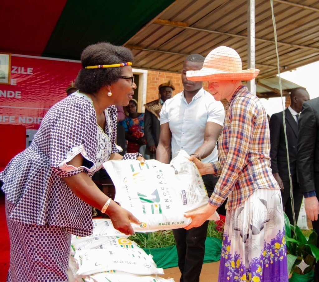 Maize flour handover to a vulnerable community member at an outreach